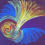 Mandala drawn with blue, yellow and orange colored pencil and pastel on dark blue paper